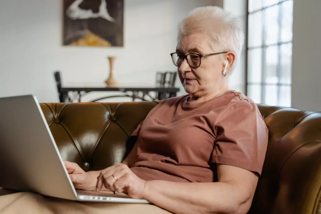 elderly woman using her laptop