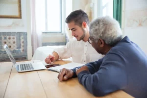 2 persons in front of a laptop